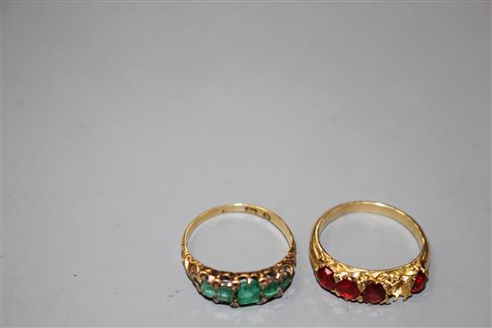 A George V yellow metal, graduated five stone emerald and diamond chip ring and one other four(ex five) stone ring.